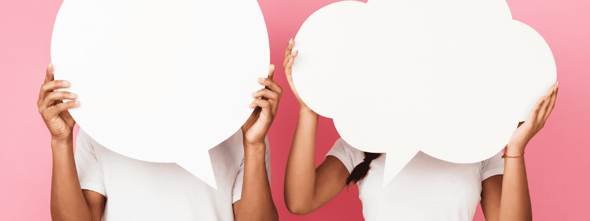 women holding up speech bubbles