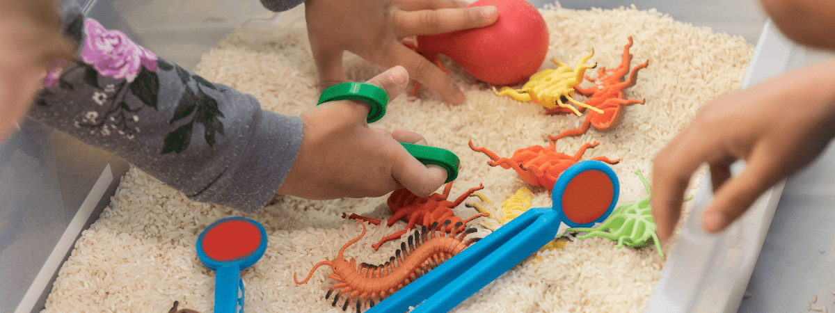 toddler playing with sensory tray