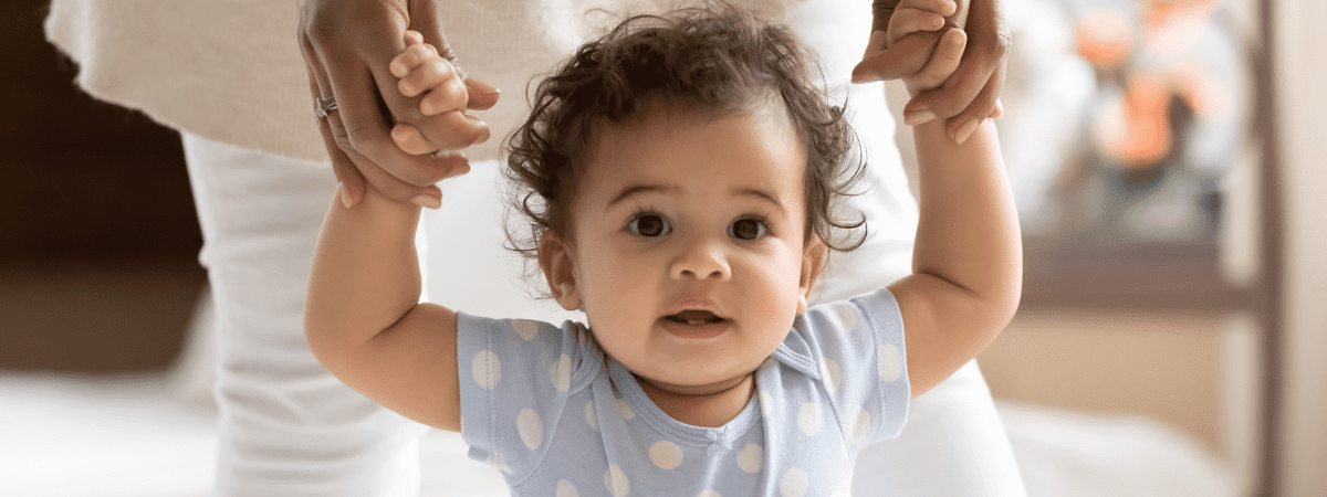 toddler holding onto mum