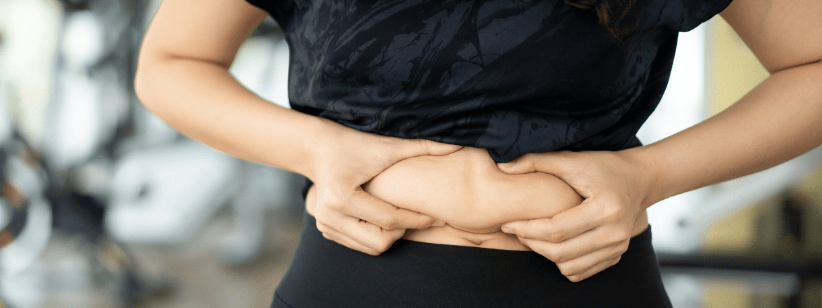 woman squeezing tummy