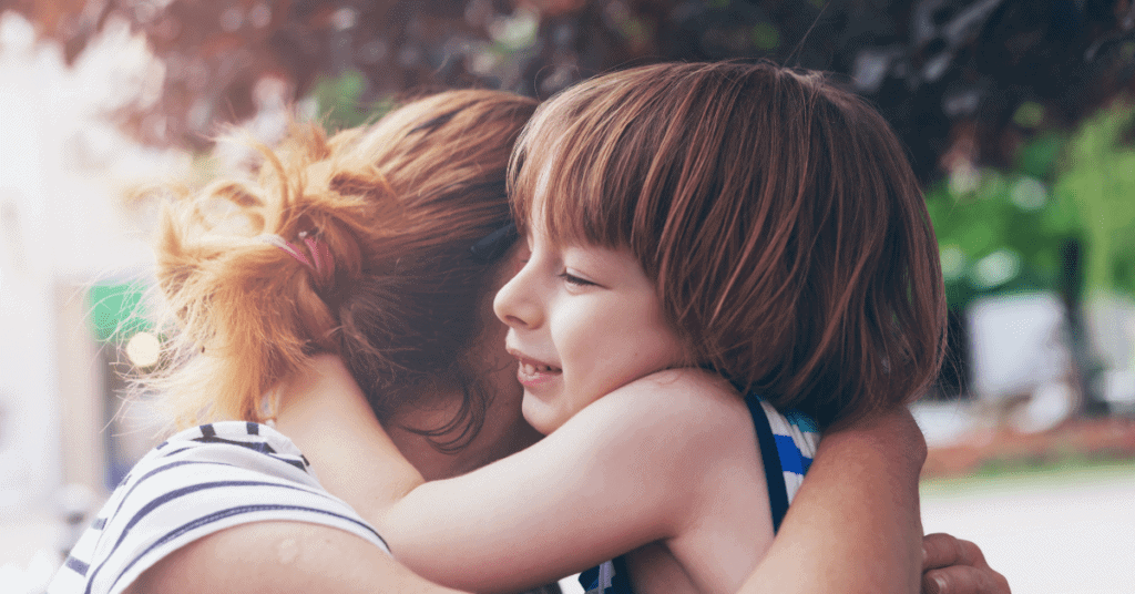 Mother and child are hugging, encouraging being open about emotions and creating a safe space.