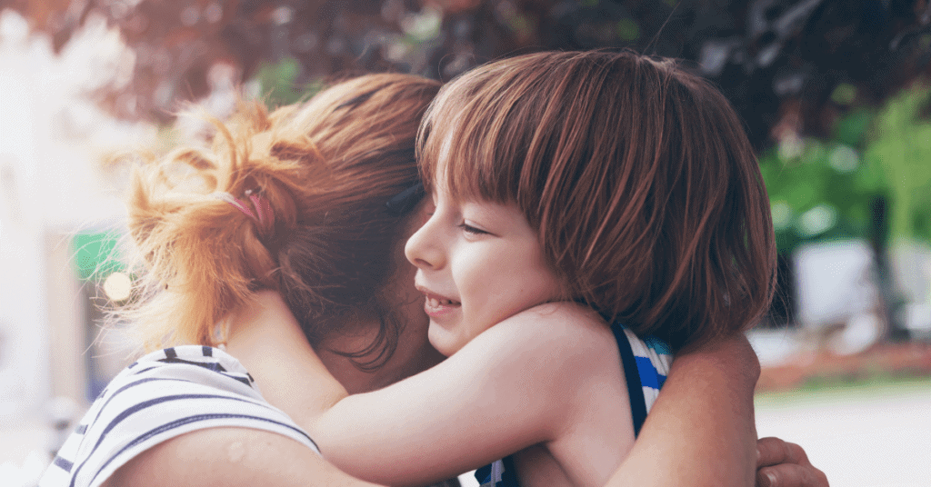 Mother and child are hugging, encouraging being open about emotions and creating a safe space.  