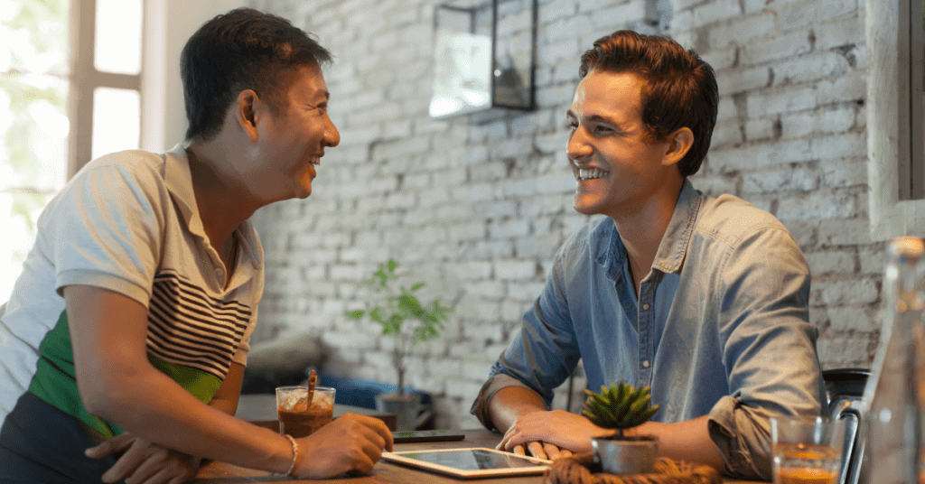 Two dad friends laughing together
