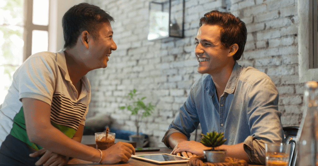 Two dad friends laughing together 