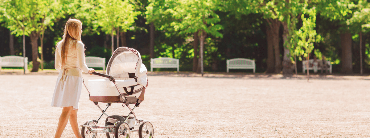 lonely mum pushing pram in empty park