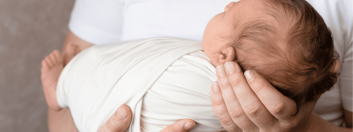 dad holding newborn baby