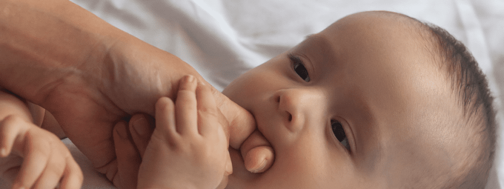 first teeth baby biting dads finger