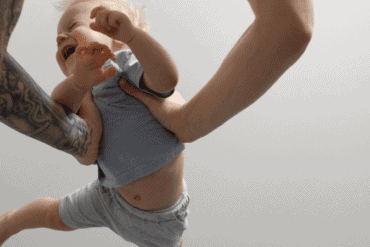 Dad swings baby in the air