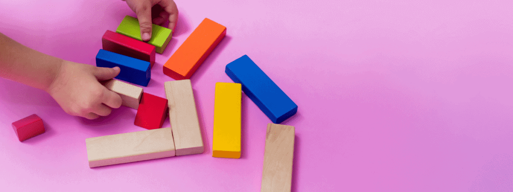 little boy playing with bricks