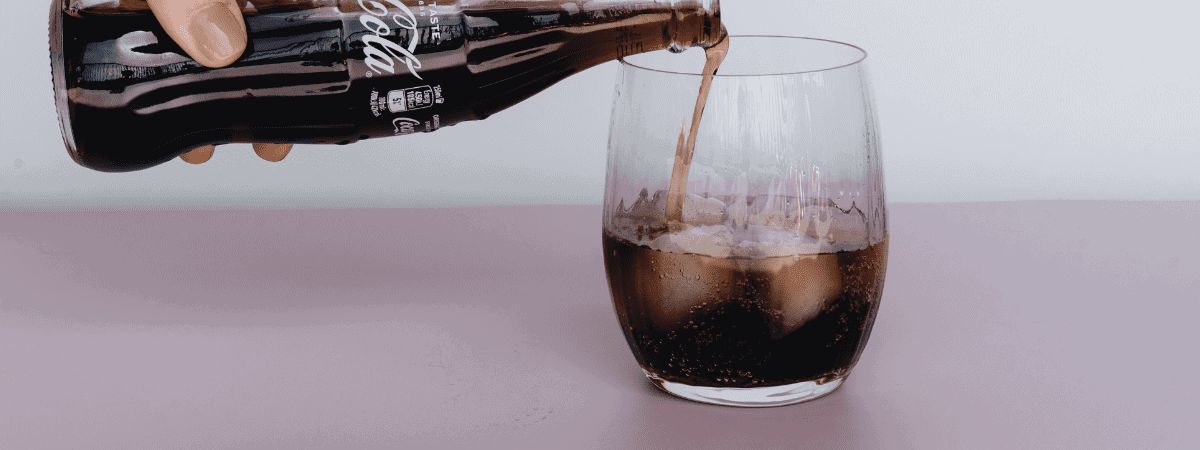 pouring cola into a glass