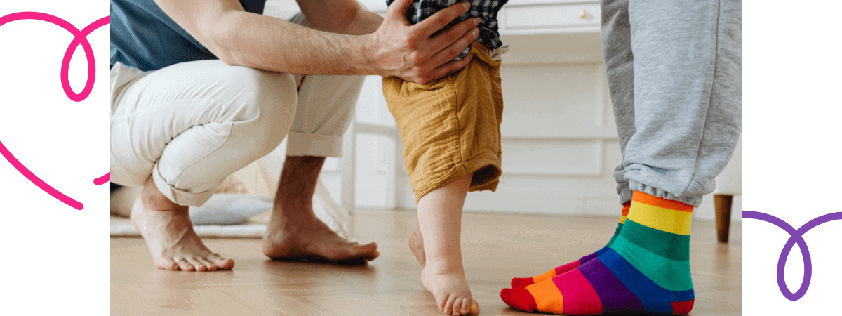 close up of parent with hands round a toddler's waist