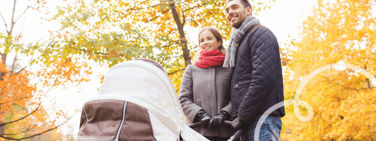 A mother and baby push their newborn in a stroller, one of the essentials that is needed on your checklist. 