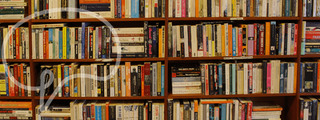 Image shows multiple shelves piled high with books. 