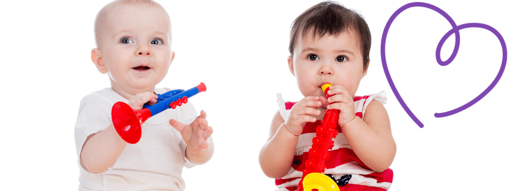 Two babies play on plastic toy instruments.