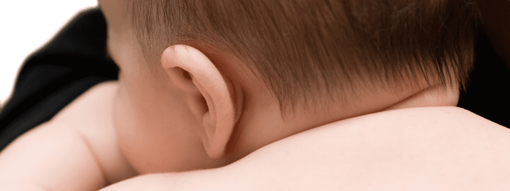 To demonstrate sound, this image shows the back of a baby's head, mostly focussing on the ear.
