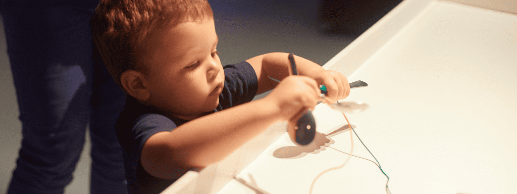 Things to do in leicester: image shows a toddler interacting with an exhibit.