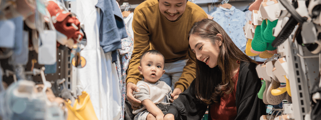 Leicester things to do with a baby: mother, father and baby all look around in a baby shop