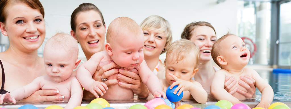 Things to do for families in Cardiff: image shows a row of mothers and babies in a swim class