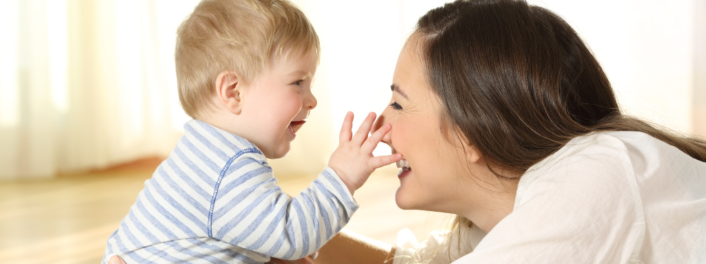 Baby and mother playing together