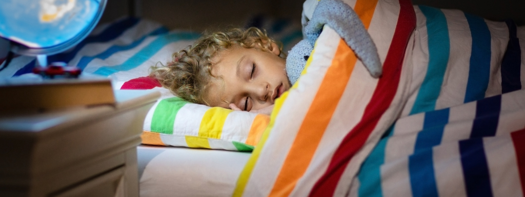 autism and sleep in children - image shows a child sleeping in their bed.