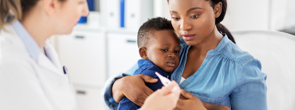 baby's first cold - image shows a mother and son at the doctors with a thermometer