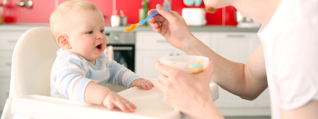 First Highchair - image shows a baby in their highchair being fed