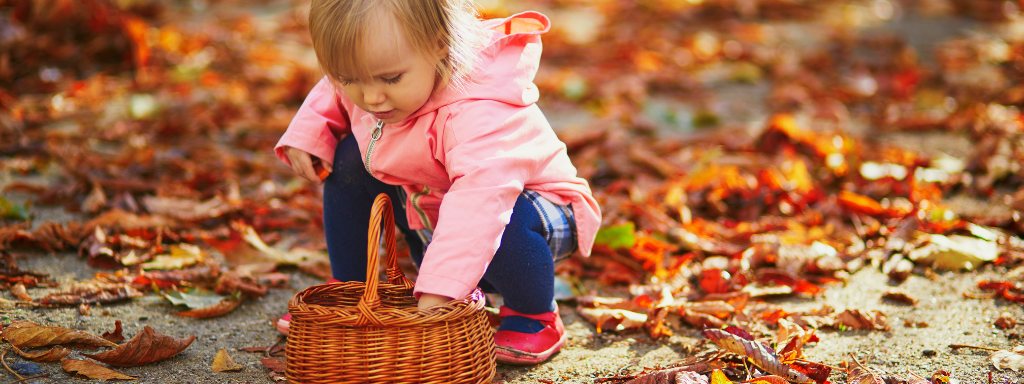Developmental Activities With Your Toddler - image shows a toddler collecting 'treasure'