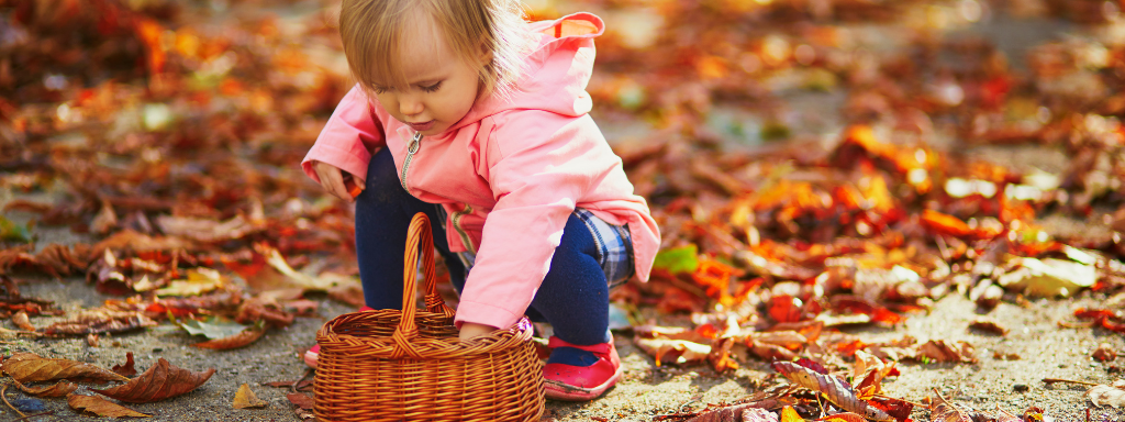 Developmental Activities With Your Toddler - image shows a toddler collecting 'treasure' 