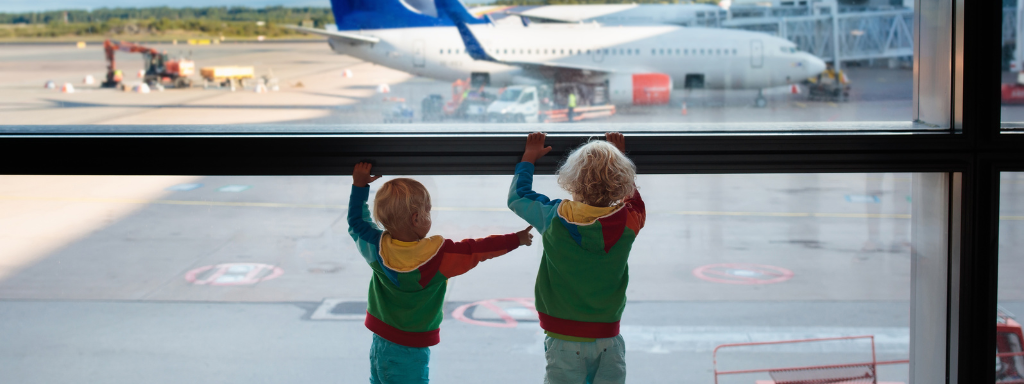 Toddler waiting at the airport for early boarding.