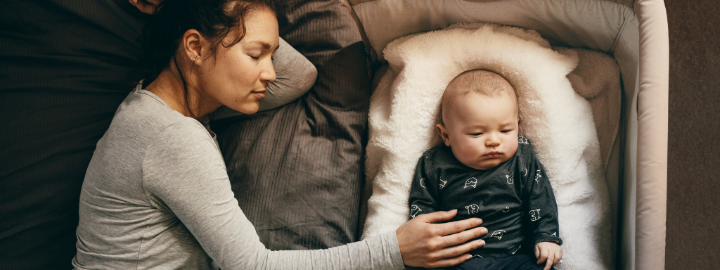 child sleep tips -image shows a mother sleeping next to her baby