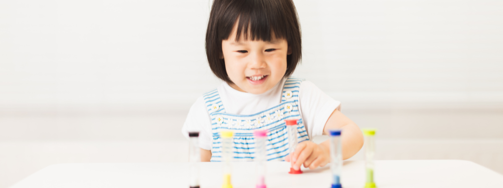 A little girl looks at timers 