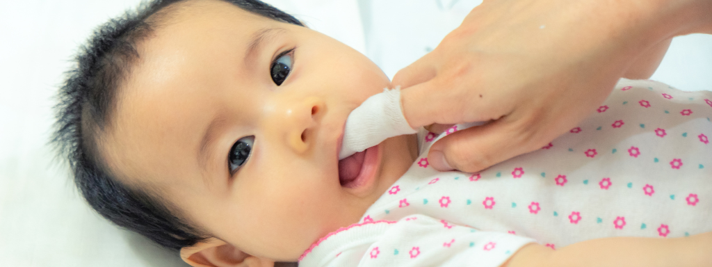 A baby having their teeth brushed