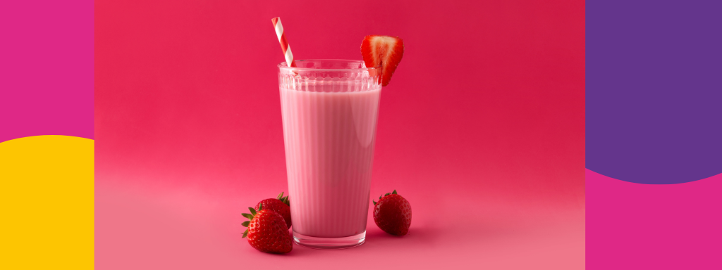 A strawberry milkshake with a straw 