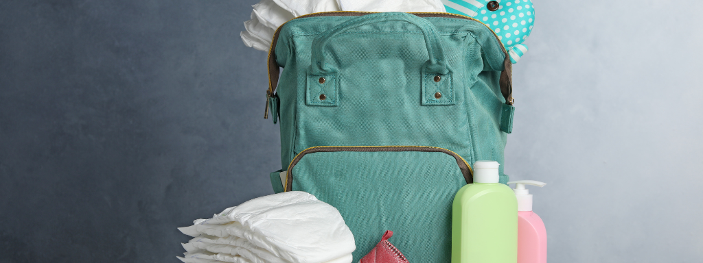 baby shower gifts - the photograph shows a baby changing bag with nappies next to it