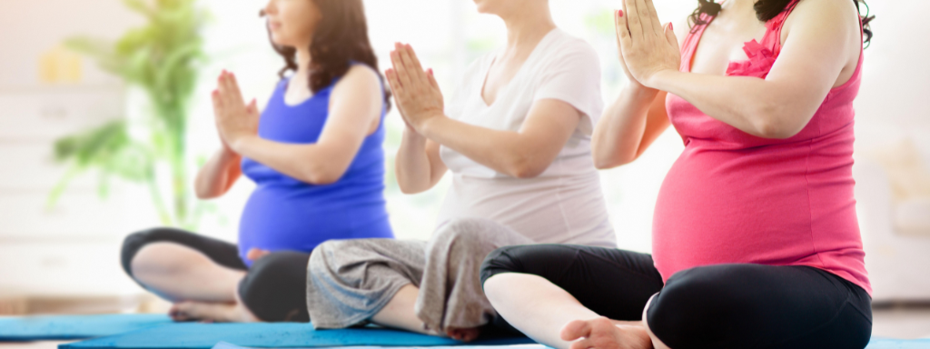 pregnancy brain - the photograph shows three pregnant women sitting in a row on yoga mats in a yoga pose