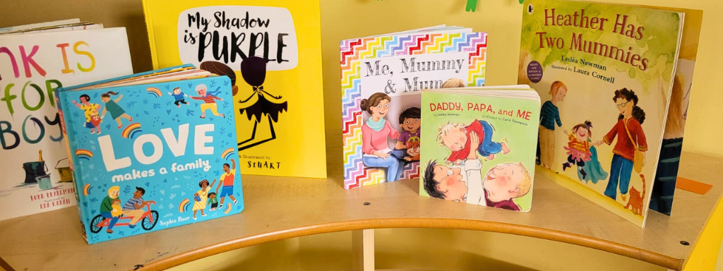 LGBTQ+ children's books - the photograph shows a selection of books for children, including 'Heather Has Two Mummies' and 'Daddy, Papa and Me'.