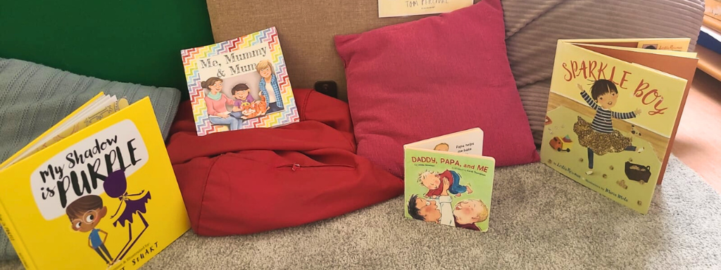 LGBTQ+ children's books - the photo shows a selection of children's books, including 'Sparkle Boy' and 'My Shadow is Purple'.